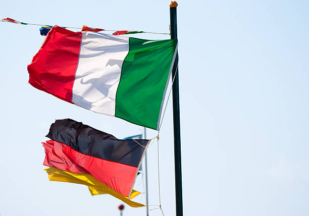 istock italy and germany flag against blue clear sky 182882588