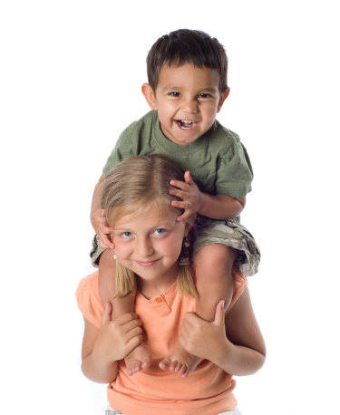 Little boy riding on girl's shoulders - white background