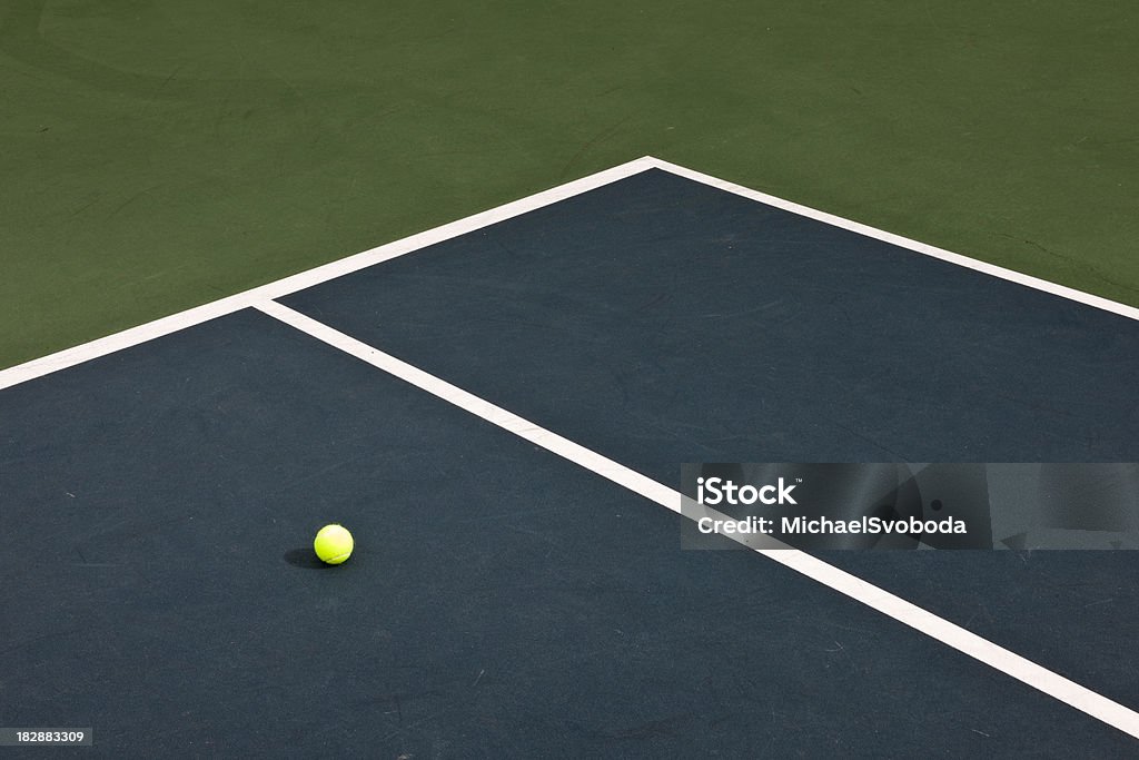 Tennis Ball A tennis ball lying on an outdoor court. Baseline Stock Photo