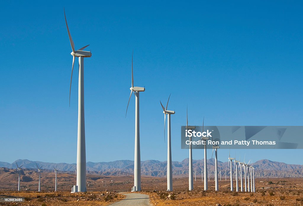 Wind turbines near Palm Springs, CA Wind Farm with numerous wind trubines line the mountain pass near Palms Spring, CA Blue Stock Photo