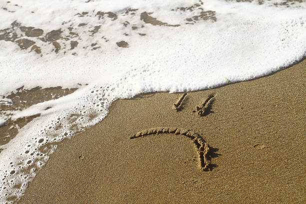 istock sad smile on the beach 182883800
