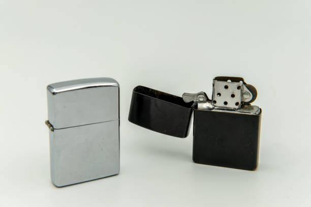 istock Black and silver metal lighters against a white background 1828847302