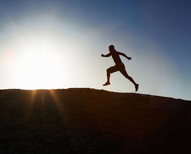 istock Training - Silhouette image of a man running outdoors 182884764