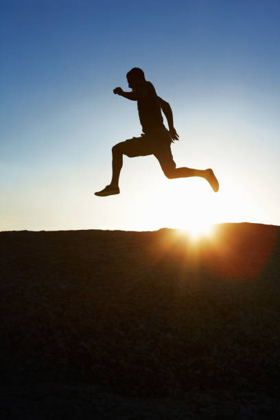 istock Silhouette image of a man running against the sky 182885194