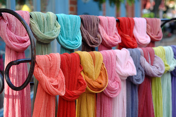 Rack of multicolored hip scarves stock photo