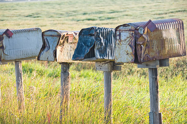 istock Row of damaged rural mailboxes. 182885907