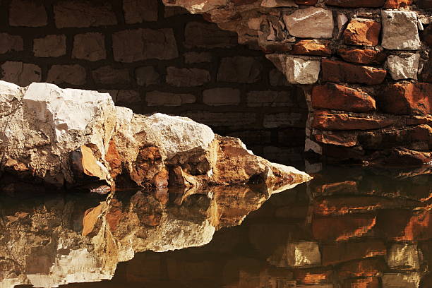 Stone wall ruin of an historic dwelling reflected in standing water.  Yavapai County, Arizona, 2010.
