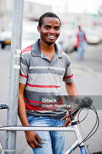 Smiling African Man In Street With Bicycle Stock Photo - Download Image Now - 20-29 Years, Adult, Adults Only