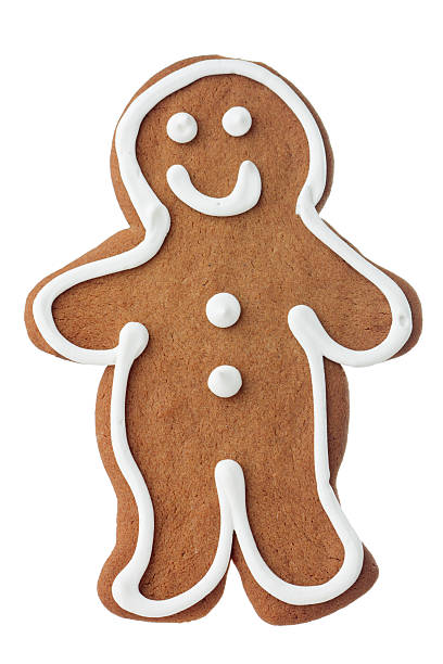 Vertical, isolated on white view of one smiling gingerbread man cookie. It is individually decorated with white icing. Baked, frosted gingerbread man cookies are associated with the Christmas holiday season.