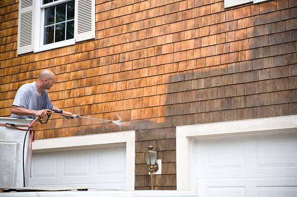 Man Powerwashing a house stock photo