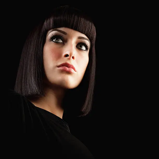 Photo of Beautiful Brunette Woman with Blunt Hairstyle on Black Background