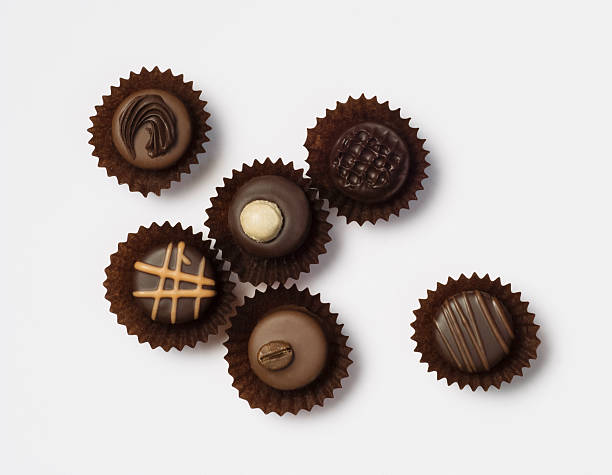 istock Different chocolate pralines on white background 182888236