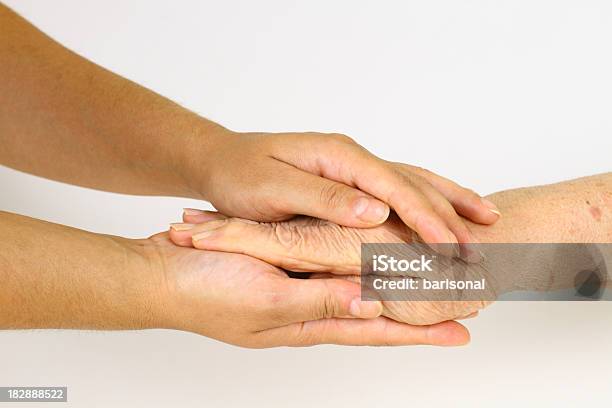 Old Hand In Young Hands Stock Photo - Download Image Now - Consoling, Giving, Holding Hands