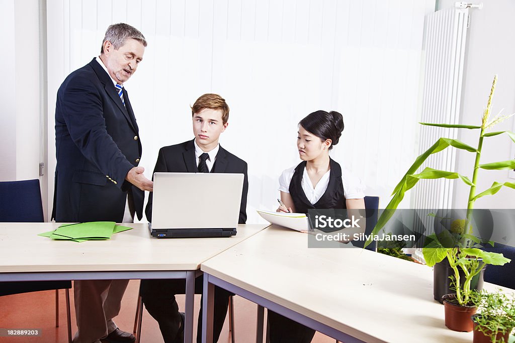 businessteam discussion "small business team at desktop, green folders and plantshere you can see more of my" Active Seniors Stock Photo