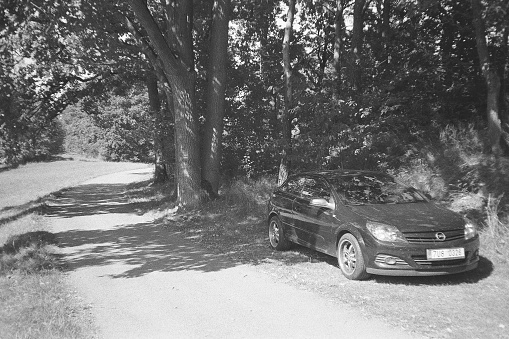 Car at road in Zahradky near Ceska Lipa on September 9, 2023 on analogue photo