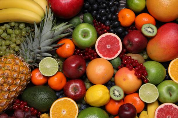 istock Different ripe fruits and berries as background, top view 1828892149