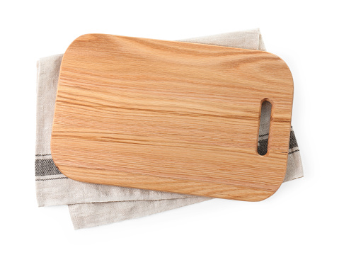 Wooden cutting board and kitchen towel isolated on white, top view
