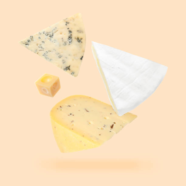 istock Different kinds of cheese falling on beige background 1828893242