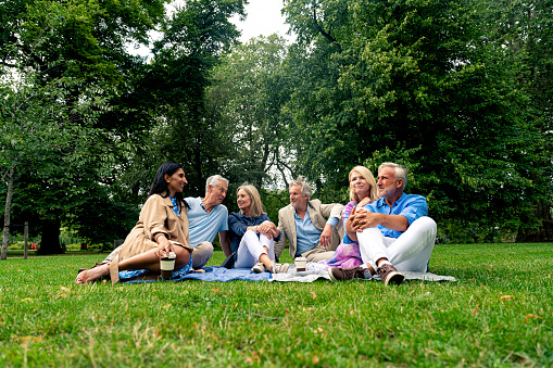Group of old friends spending time together in the main parts of London, visiting the Westminster area and St. James Park. Old buddies reunion. Concept about third age and seniority