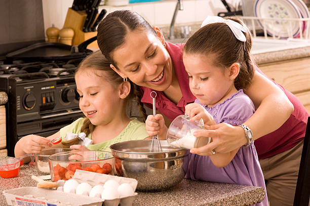 istock Mom with her two daughters baking in the kitchen 182889539