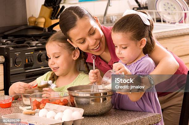 Mom With Her Two Daughters Baking In The Kitchen Stock Photo - Download Image Now - 30-39 Years, 4-5 Years, 6-7 Years