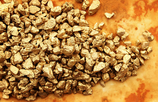 Gold Nuggets Heap of gold nuggets on grunge background. goldco precious metals complaints stock pictures, royalty-free photos & images