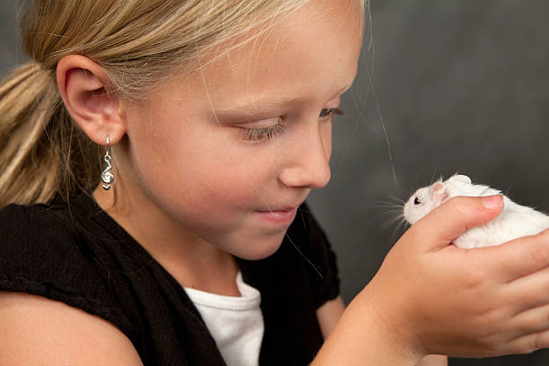 istock Little Girl with Pet Hamster 182889575
