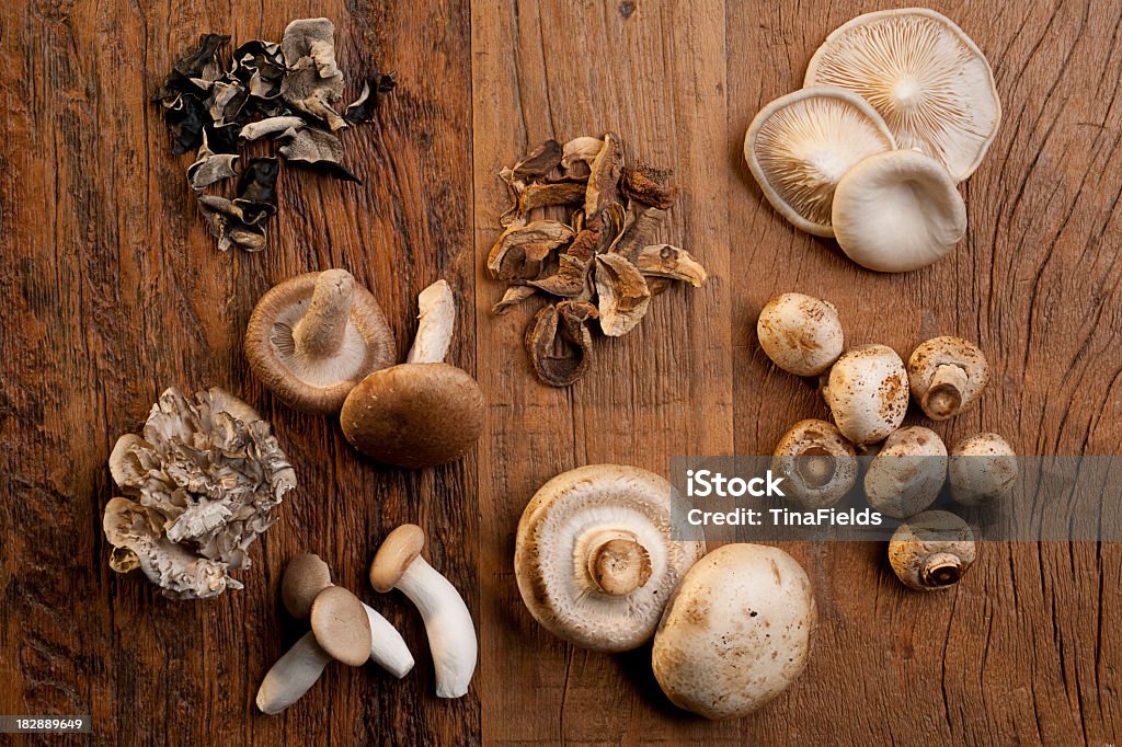 Various mushrooms used on cooking Mushrooms assortment in a wooden table. Edible Mushroom Stock Photo