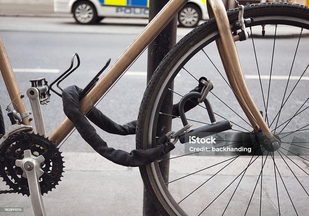 Cycle security Bike locked up in conspicuous space near Police car. Bicycle Lock Stock Photo