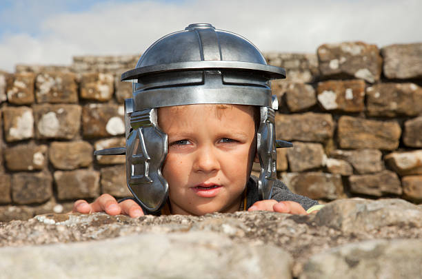 Preschool age boy 5 years old with bicycle helmet on his head, isolated on white background