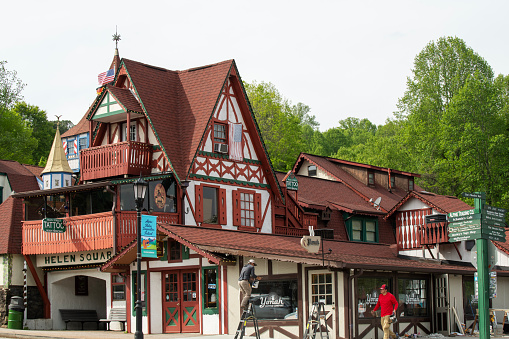 Helen, USA - April 21, 2023. Painters working on building in downtown Helen, a German themed town in Georgia, USA