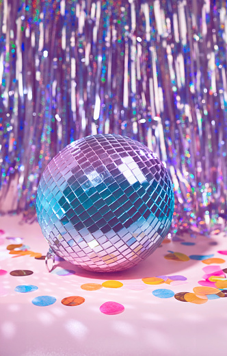 A Purple and Blue Mirror Ball, Disco Ball on a Iridescent Tinsel background Party Scene in Dreamy Pastel Colors