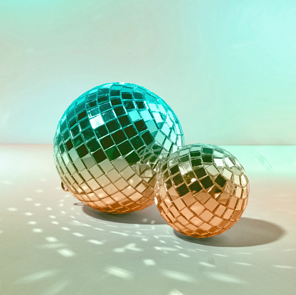 Two Pastel Green Disco Ball and Mirror Balls on a Green Background