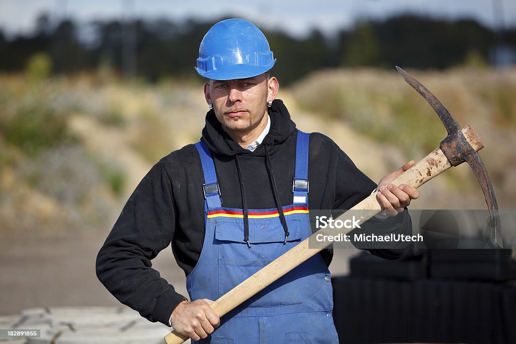Manual Worker Holding A Hoe A manual worker holding a hoe on a sunny day. 20-29 Years Stock Photo