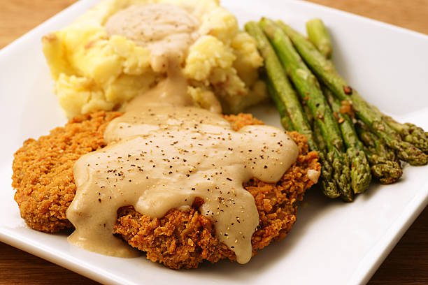 istock A plate of fried chicken, mashed potatoes and asparagus  182893181
