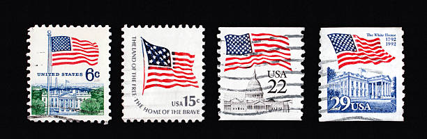 Four first class stamps with American flags stock photo