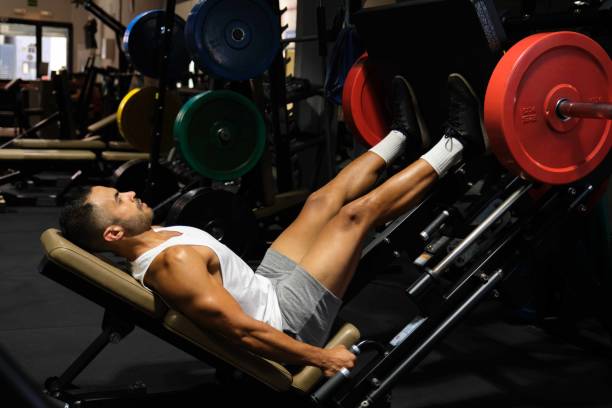 istock Strong Latin man doing leg press at a gym. 1828938394