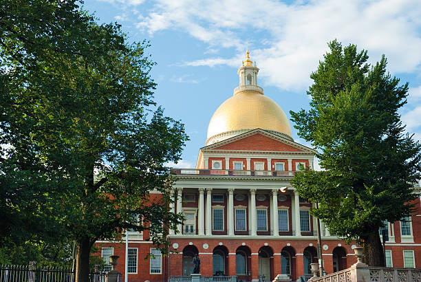 istock Massachusetts State House with blue sky and trees in Boston 182893970