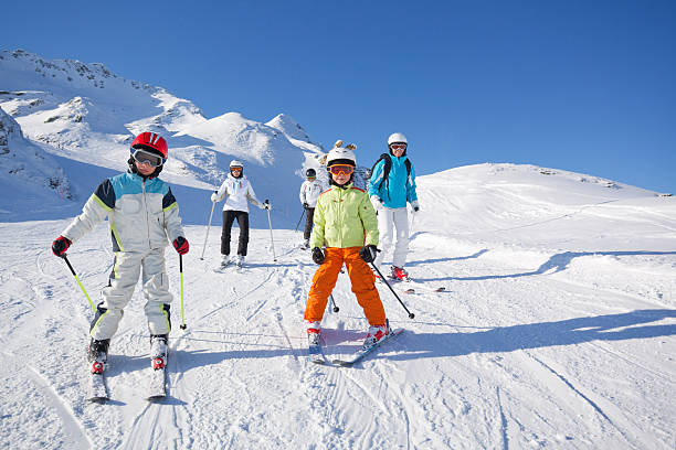 istock children and adults skiing on piste 182894295