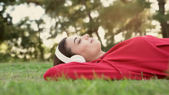 Woman listening to music with headphones in the nature