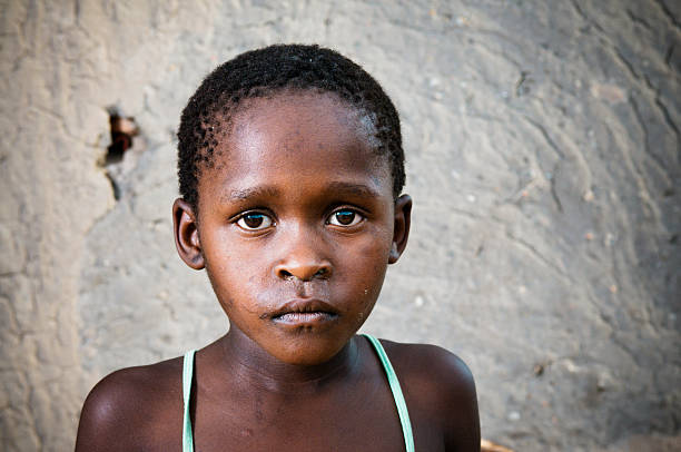 istock Young Xhosa girl infront of mud wall 182894672