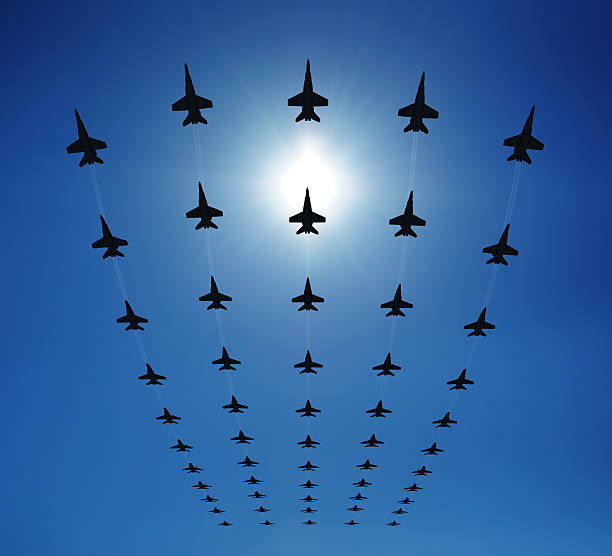 F18 silhouettes in the sky Rows of fighter jets flying in the sky. Clear sunny day. Check out some other airplane files: us navy photos stock pictures, royalty-free photos & images