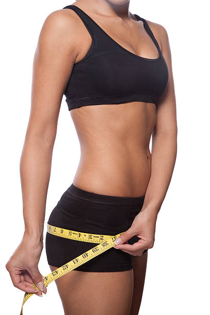 istock Beautiful woman is measuring her hips 182895239