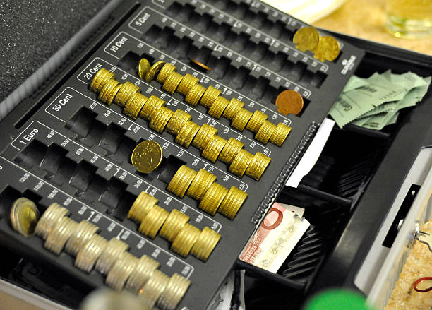 istock coins in cash register 182895302