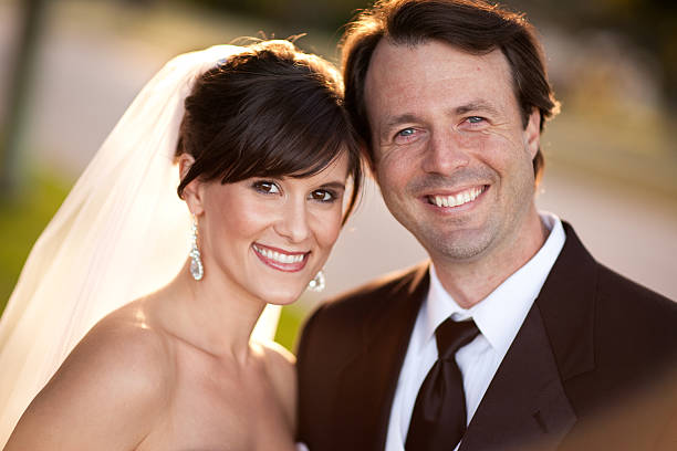 istock Backlit Happy Bride and Groom Smiling Together Outside 182895353