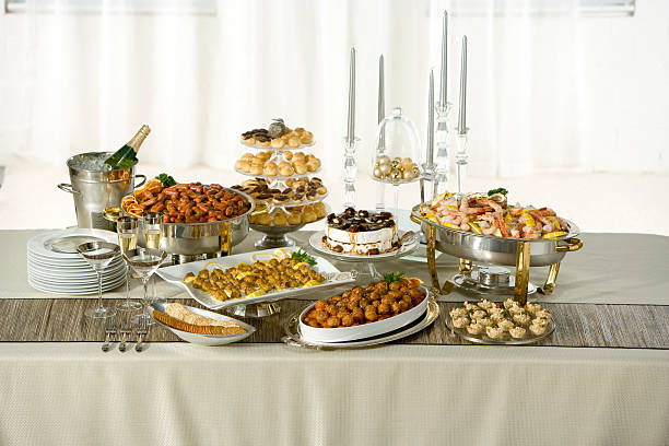 Long table with holiday buffet served Holiday Buffet food service occupation food and drink industry party buffet stock pictures, royalty-free photos & images