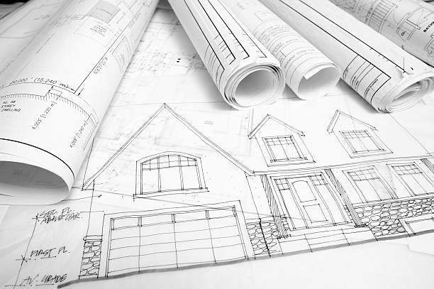 istock Construction drawing plans for a house rolled up together 182895482