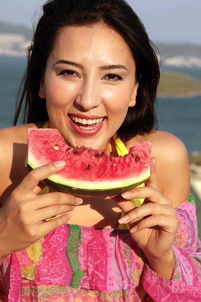 istock Young woman with watermelon 182895503
