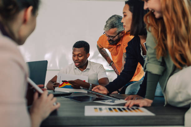 istock A multicultural financial adviser showing charts at boardroom. 1828956347