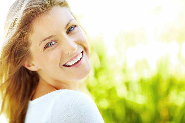 istock Beautiful young lady smiling against natural background 182895652